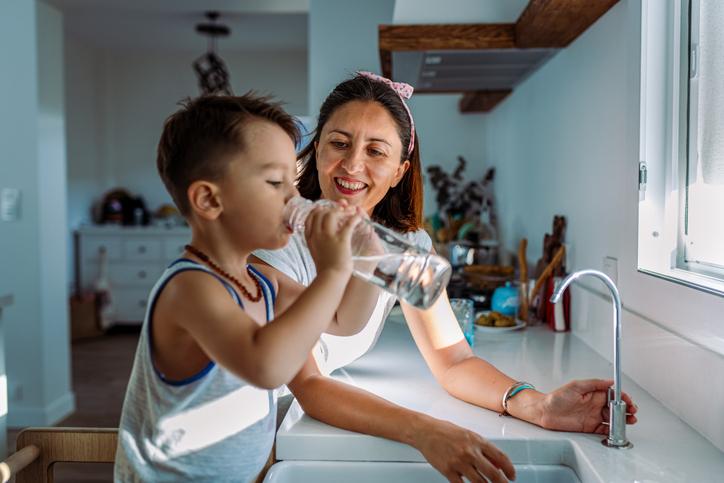 A mother and child at a sink